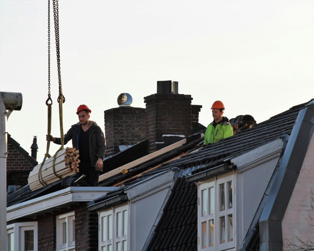 Workers operate on a rooftop under construction